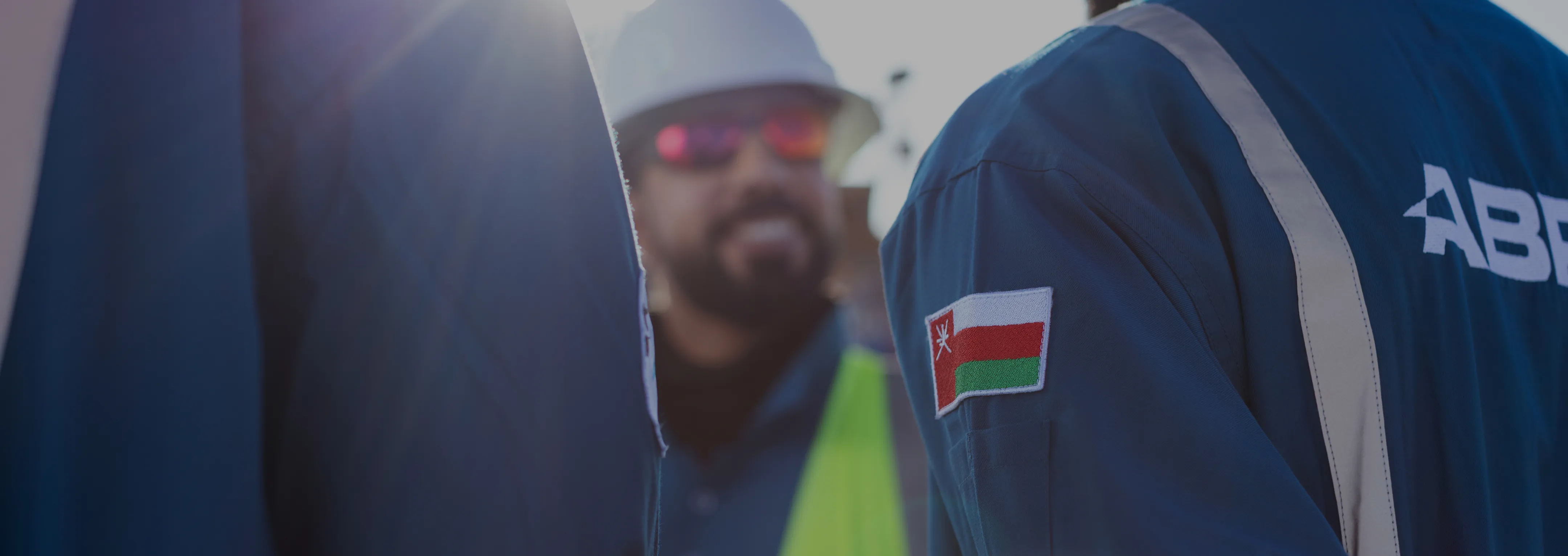 ABRAJ well services crew working on a drilling rig floor in Oman at sunrise